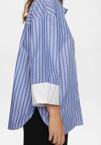 Blue and white striped shirt with a buttoned collar, long sleeves, white cuffs, and a slight tail hem. Made of lightweight fabric.