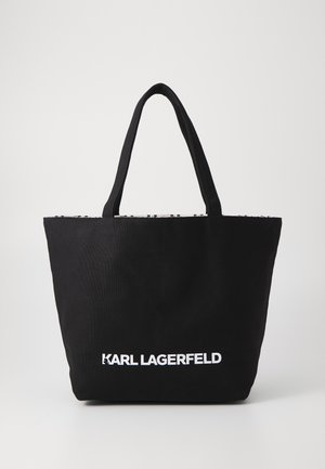 Black canvas tote bag with two sturdy handles, featuring white "KARL LAGERFELD" logo at the bottom and textured upper rim.