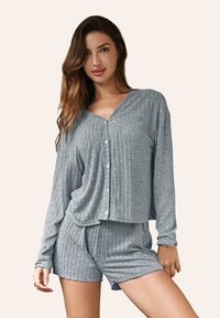Set di abbigliamento da soggiorno grigio a costine composto da una camicia a maniche lunghe con bottoni e scollatura a V e pantaloni corti coordinati, realizzato in un tessuto morbido.