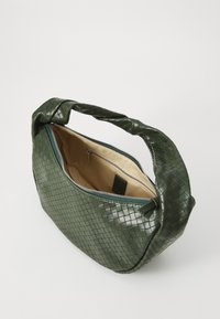 Dark green woven leather handbag with a thick braided handle, zip closure, and a beige interior lining with an additional zip pocket.