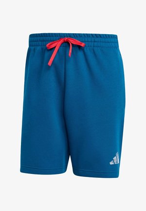 Blå treningsshorts laget av mykt stoff, med elastisk midje og rød snor samt en hvit merkelogo på den nedre siden.
