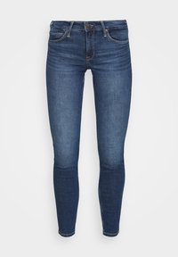 Mörkblå smala jeans i denim med medelhög midja, fem fickor och guldtråd accenter. Slät struktur, avsmalnande ben.