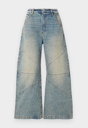 Φαρδιά παντελόνια τζιν ανοιχτού μπλε χρώματος με ψηλή μέση, κούμπωμα με κουμπί και φερμουάρ, μπροστινές τσέπες και διαγώνιες λεπτομέρειες στη ραφή.