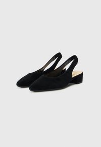 Sorte ruskind slingback-sko med spids tå og lav blokhæl. Glat tekstur og minimalistisk design med åben hæl.