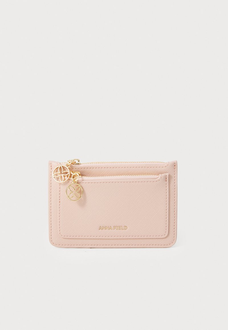 Pink textured wallet with a zippered pocket, gold hardware accents, and an embossed brand name. Compact and rectangular design.