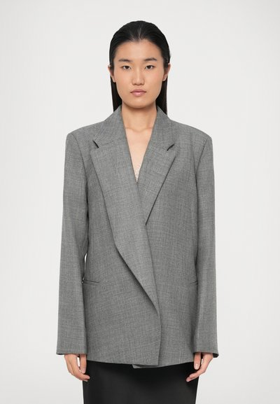 Gray, oversized blazer with a textured weave, notched lapels, and side pockets. Single button closure, long sleeves, and a relaxed fit.