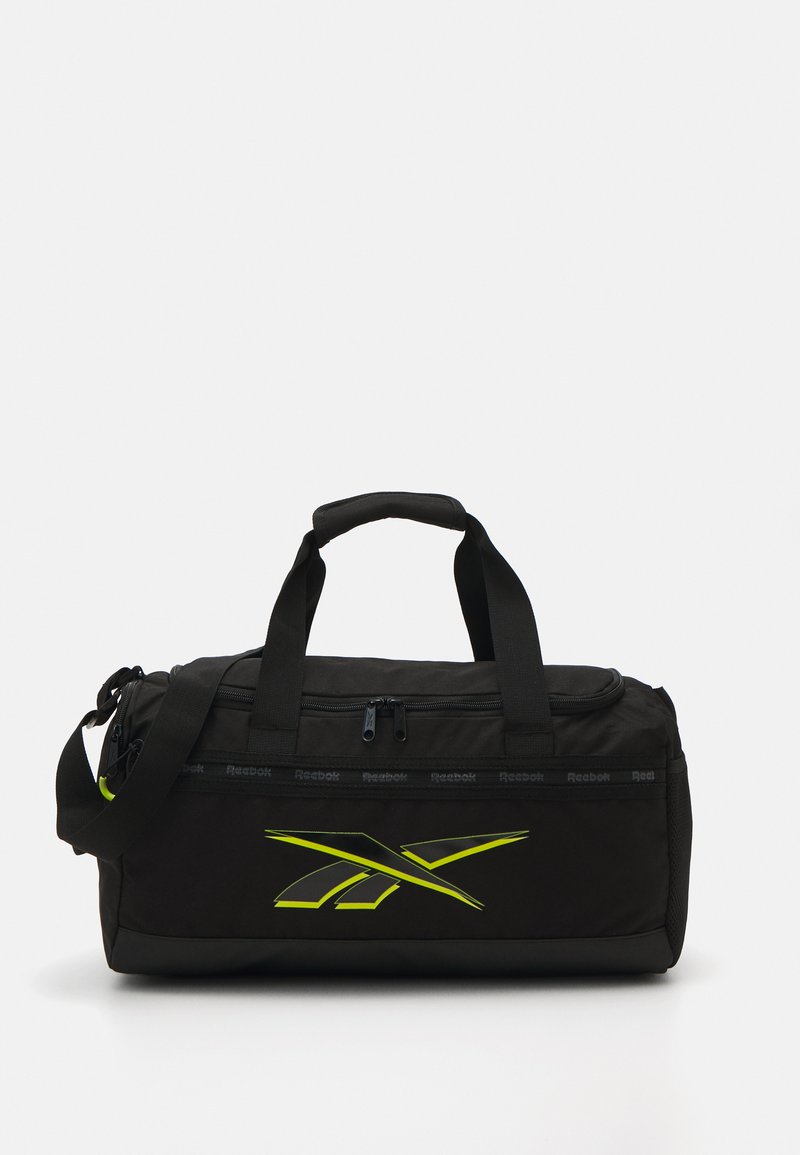 Black duffel bag made of durable fabric, featuring a zippered top, dual handles, and a bold yellow Reebok logo on the front.