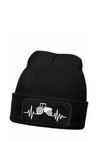 Black knit beanie featuring a black patch with a white tractor graphic and heartbeat line. The fabric has a ribbed texture.