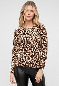 Leopardprint lange mouwen top met een ronde hals, gemaakt van zachte stof. Kenmerkt zich door zwarte en bruine patronen op een beige achtergrond.