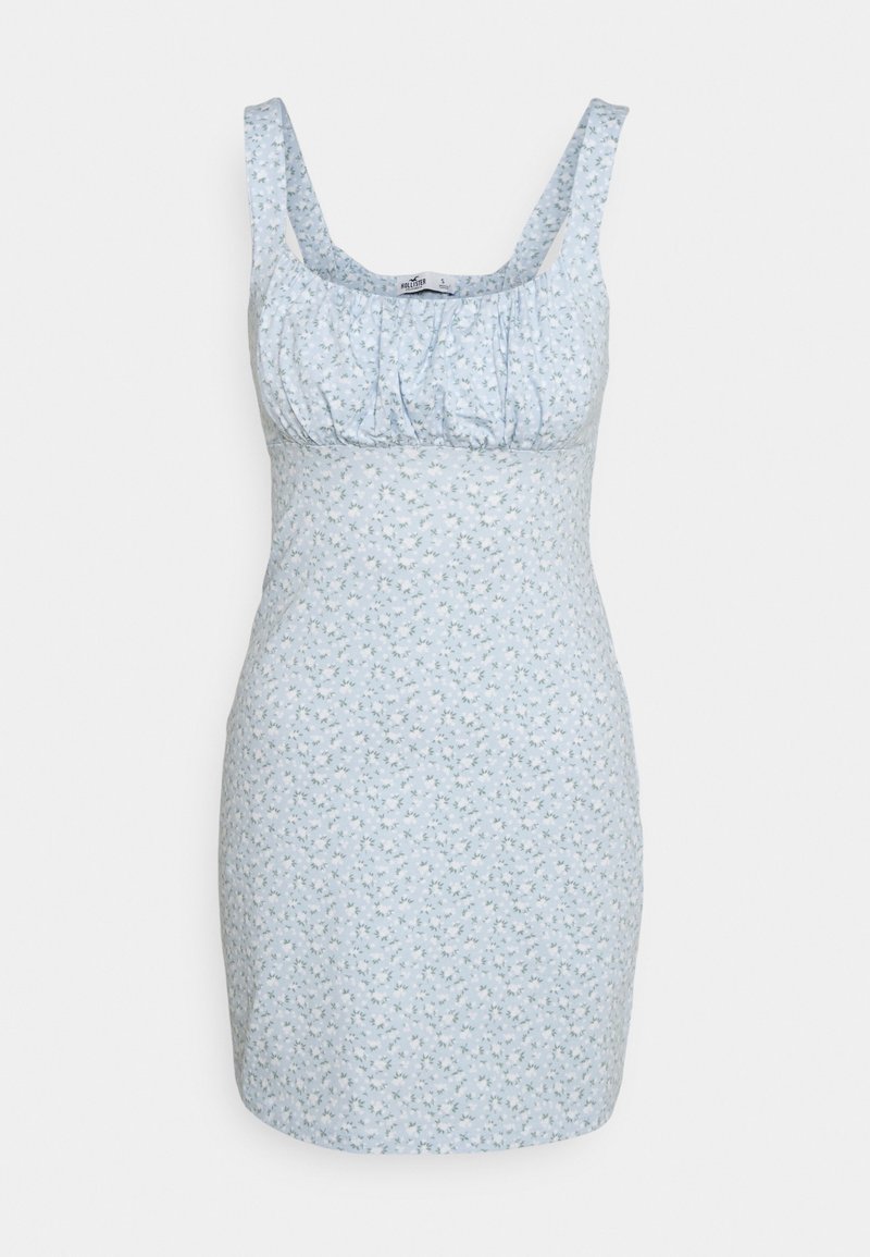 Robe florale bleu clair avec une coupe ajustée, larges bretelles et corsage froncé. Présente un petit motif floral répété sur l'ensemble.