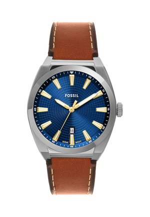 Analog wristwatch with a blue textured dial, gold hour markers and hands, a date window at 6 o'clock, and a brown leather strap.