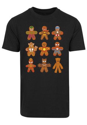 Black t-shirt featuring illustrated gingerbread figures in various superhero costumes, using orange and brown colors with white accents.