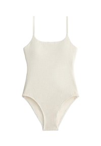 Maillot de bain une pièce blanc texturé avec fines bretelles et encolure arrondie, présenté sur un fond uni.