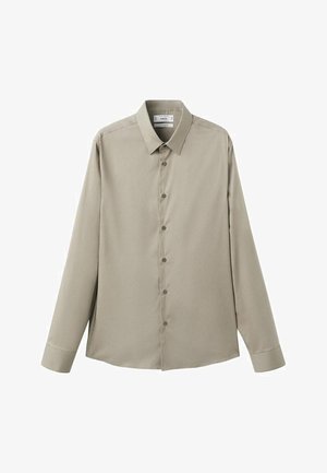 Long-sleeve button-up shirt in light beige fabric, features a classic collar, front button closure, and rounded hem. Smooth texture.