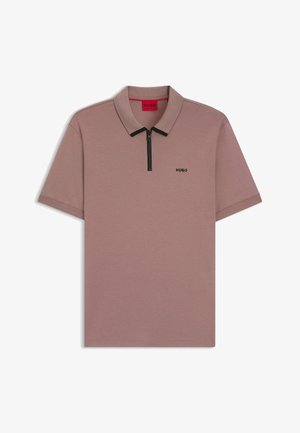 Short-sleeve polo shirt in muted mauve with a black zipper and collar. Features a small black logo on the left side. Smooth texture.