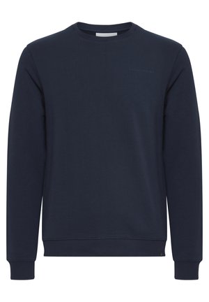 Tums zila treniņjakas krekls, izgatavots no kokvilnas maisījuma, ar apaļu kakla izgriezumu un ribotas aproces un apakšmali. Smalks reljefs logo detalizējums uz krūtīm.