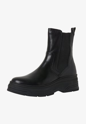 Black leather ankle boot with elastic side panels, rounded toe, and textured rubber sole. Chunky platform design enhances stability.