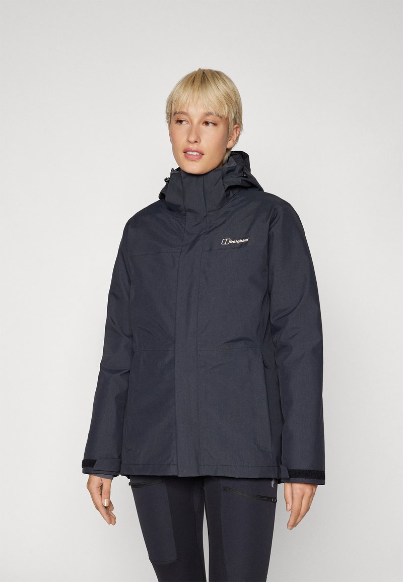 Navy waterproof jacket with a high collar, adjustable hood, and front pockets; features a zip and velcro closure for protection against elements.