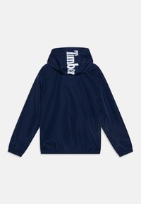 Navy blue rain jacket with a hood. Features a white "Timber" logo on the back and elastic cuffs. Smooth, water-resistant material.