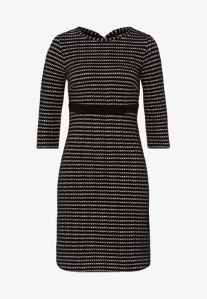 Zwart-wit gestreepte jurk met een getailleerd ontwerp, ronde halslijn en driekwart mouwen. Heeft een effen zwarte tailleband.