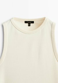 Ärmelloses cremefarbenes Tanktop mit rundem Halsausschnitt und geripptem Saum. Hergestellt aus einem weichen Stoff, mit einem einfachen, klaren Design.