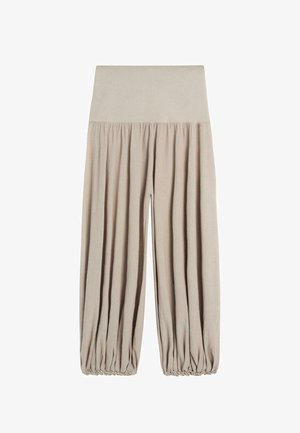 Pantalon beige taille haute à jambes larges avec bords élastiqués et tissu froncé le long des jambes pour une coupe décontractée.