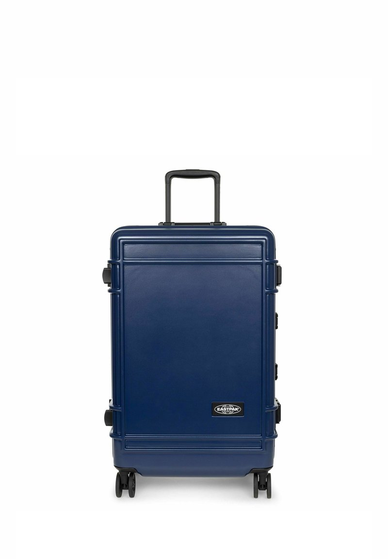 Navy blue hard-shell suitcase with a textured surface, extending handle, four wheels, and logo accent on the front.
