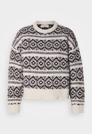 Gebreide trui in crème en donkerbruin. Voorzien van een geometrisch patroon, geribbelde halslijn en zoom, lange mouwen en een cropped snit.