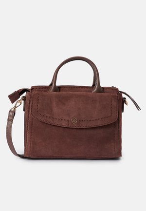 Brun ruskindstaske med læderhåndtag, frontlomme med klap og knap samt aftagelig skulderrem på hvid baggrund.