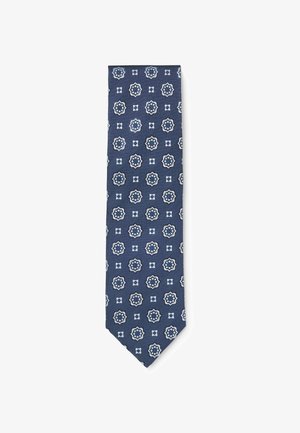 Marineblauwe stropdas met herhalend patroon van witte en blauwe bloemmedaillons gerangschikt in een raster.