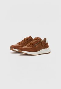 Brown suede and leather sneakers featuring a white midsole and rubber outsole, with lace-up closure and side zipper detail.