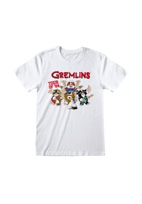 Weißes Baumwoll-T-Shirt mit einem bunten Grafikdesign, das cartoonartige Gremlins zeigt. Der Text enthält "Gremlins" und "Tour von '84" in fetten roten Buchstaben.