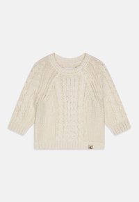 Pull en tricot crème avec un design en câble texturé, col rond et fermeture à deux boutons à l'épaule. Présente des poignets et un ourlet côtelés.