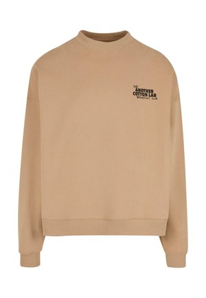 Beige cotton sweatshirt with a high neckline, long sleeves, and ribbed cuffs. Features "THE ANOTHER COTTON LAB BREAKFAST CLUB" in black print.