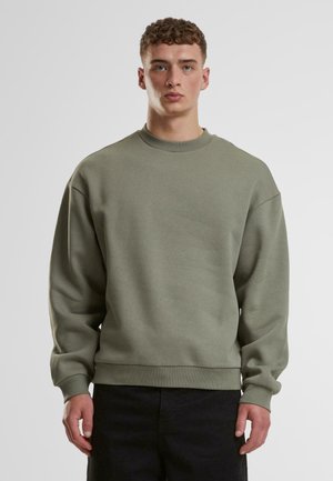 Light green sweatshirt with a crew neckline, dropped shoulders, and ribbed cuffs. Made of a soft fabric with a smooth texture.