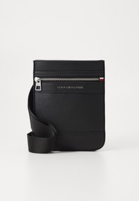 Black synthetic leather crossbody bag with zippered front pocket, logo detail, and adjustable strap. Smooth texture with a clean, minimalist design.