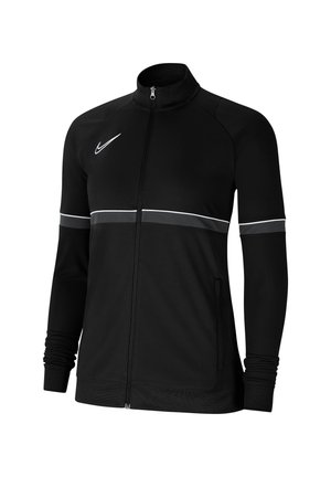Zwarte sportjas met volledige ritssluiting, witte en grijze streep over borst en mouwen, opstaande kraag en Nike Swoosh-logo op de borst.