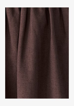 Tekstūrēta tumši brūna auduma virsma ar mīkstiem krokām un redzamu austs rakstu, radot niansētas ēnas un dziļumu.