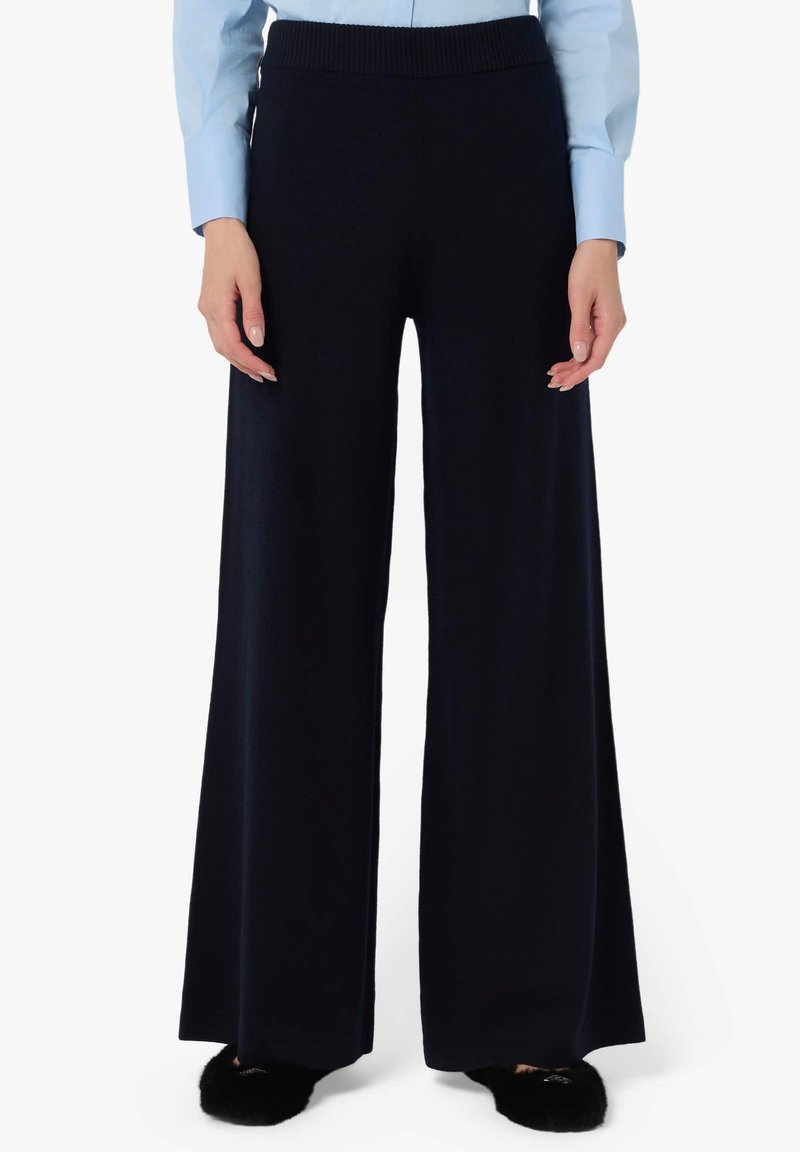 Pantaloni a gamba larga blu navy realizzati in tessuto morbido con vita a costine, caratterizzati da una vestibilità rilassata e una texture liscia per un comfort ottimale.