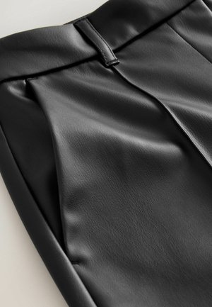 Black faux leather pants with a smooth texture, featuring a tailored waistband and front pleats. The design showcases a contemporary silhouette.