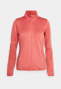 Veste zippée entièrement couleur corail avec col montant, manches longues, poches latérales zippées et panneaux texturés côtelés sur les manches et sur les côtés.