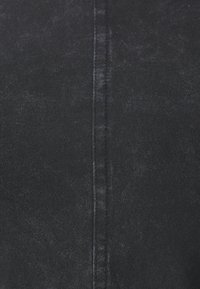Black stretch fabric with a textured appearance. Features vertical seam running down the center. Smooth, form-fitting design.
