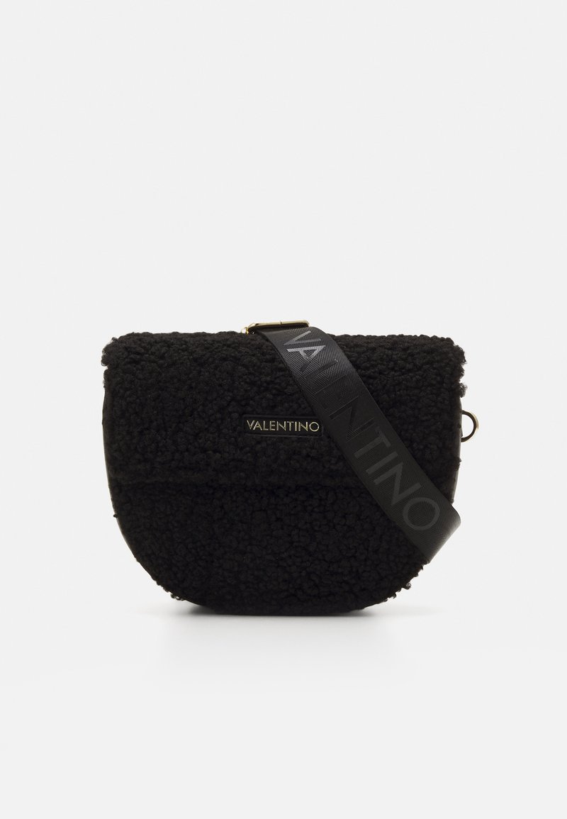 Black textured handbag made of soft, fuzzy material with a curved shape. Features a black strap embossed with "VALENTINO." Gold hardware accent.