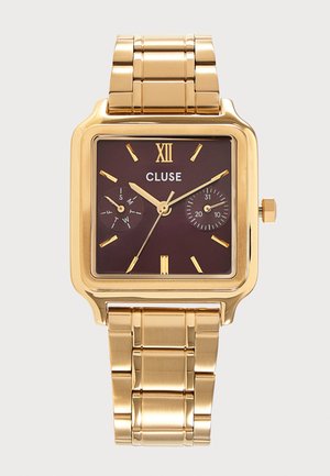 Gold metal wristwatch with square dark brown face, gold hour markers, two small dials, and a metal link bracelet band.