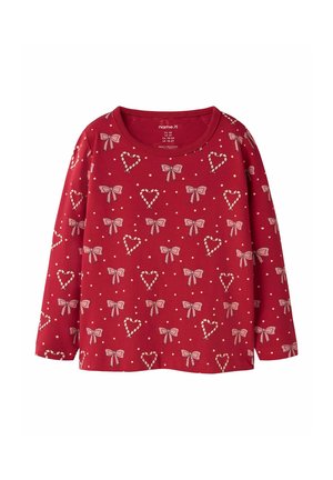 Red long-sleeve children's shirt with pink bow and heart patterns scattered evenly across the fabric.