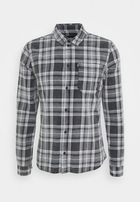 Camicia a maniche lunghe con bottoni, in un motivo a quadri nero e grigio, dotata di tasca sul petto e colletto classico. Realizzata in un tessuto morbido e strutturato.