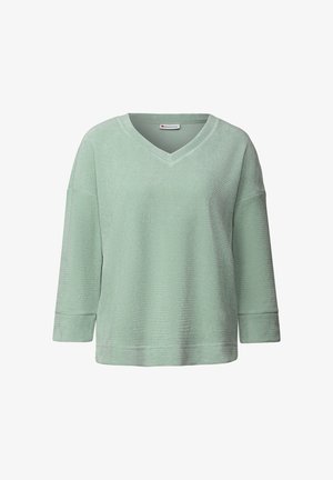 Vihreä mintunvärinen villapusero, jossa on V-mallinen kaula-aukko, kolmanneksen pituiset hihat, teksturoitu kangas ja rento leikkaus. Tagi näkyvissä kaula-aukossa.