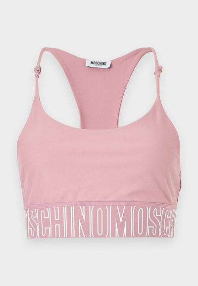 Ροζ αθλητικό σουτιέν με ρυθμιζόμενους ιμάντες και φαρδιά ελαστική ταινία που διαθέτει το λογότυπο "Moschino" με λευκό κείμενο γύρω από τη βάση.