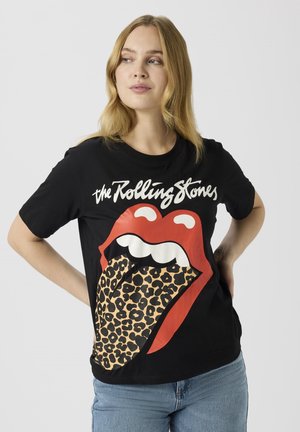 T-shirt en coton noir avec un motif de lèvres rouges, une langue à imprimé léopard et un texte blanc indiquant "the Rolling Stones". Manches courtes, col rond.