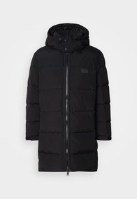 Black puffer jacket with a zip front, hood, and banded cuffs. Features stitched, puffy sections, and a small logo patch on the chest.